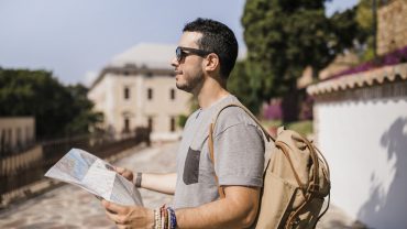 close-up-male-tourist-holding-map-his-hand